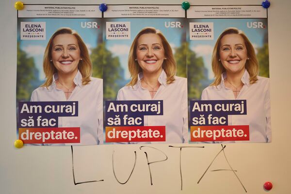 The word "Fight" is written on a board below posters of Elena Lasconi, presidential candidate for the Save Romania Union party, or USR, before it withdrew its support for her last week in favor of incumbent Bucharest mayor Nicusor Dan, at a party headquarter in Bucharest, Romania, Tuesday, April 15, 2025. (AP Photo/Vadim Ghirda)