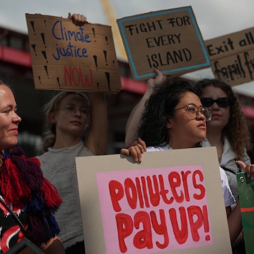 ADDS NAME - Rachelle Junsay, center, stands with other activists participating in a youth climate demonstration during the COP30 U.N. Climate Summit, Friday, Nov. 14, 2025, in Belem, Brazil. (AP Photo/Joshua A. Bickel)