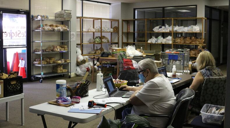 NETWorks Cooperative Ministry in downtown Tucker, provided emergency food assistance to local families three days per week throughout the pandemic. To prevent the spread of COVID-19, people checked in at a tent outside while volunteers filled a shopping cart with bags of non-perishable items and produce, when available. (William Newlin/UGA)