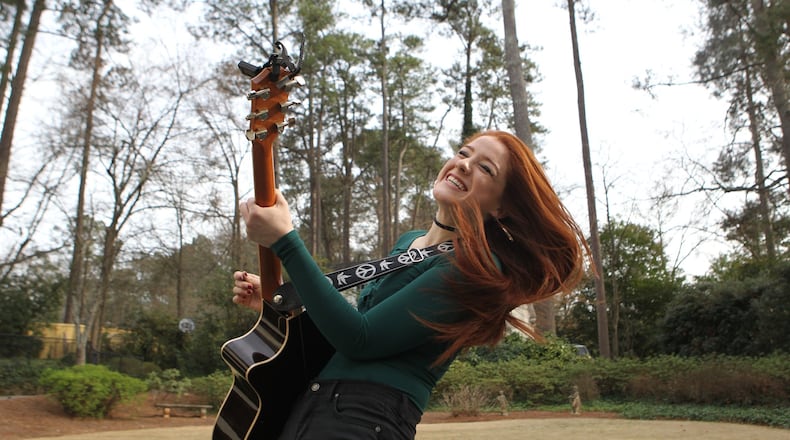 Ella Collier, 17, a local musician who experienced cardiac arrest while playing basketball at the age of 14, practices guitar at her home in Atlanta on Feb. 20, 2017. Collier turned her experience on the court into a moment of emotional growth and pursued her love of singing and songwriting. HENRY TAYLOR / HENRY.TAYLOR@AJC.COM