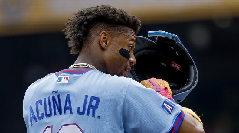 Atlanta Braves' Ronald Acuna Jr. adjusts his helmet while standing on third base against the Pittsburgh Pirates during the first inning of a baseball game, Saturday, June 6, 2026, in Atlanta. (AP Photo/Erik S. Lesser)