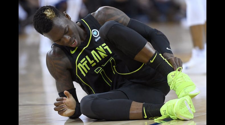<p>Dennis Schroder #17 of the Atlanta Hawks reacts after twisting his ankle against the Golden State Warriors during an NBA basketball game at ORACLE Arena on March 23, 2018 in Oakland, California.</p>