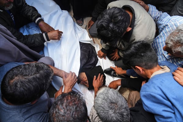 Palestinians mourn over the body of Reem Al-Akhras who was killed while heading to a Gaza aid hub, during her funeral at the Nasser Hospital in Khan Younis, southern Gaza Strip, Tuesday, June 3, 2025. (AP Photo/Abdel Kareem Hana)