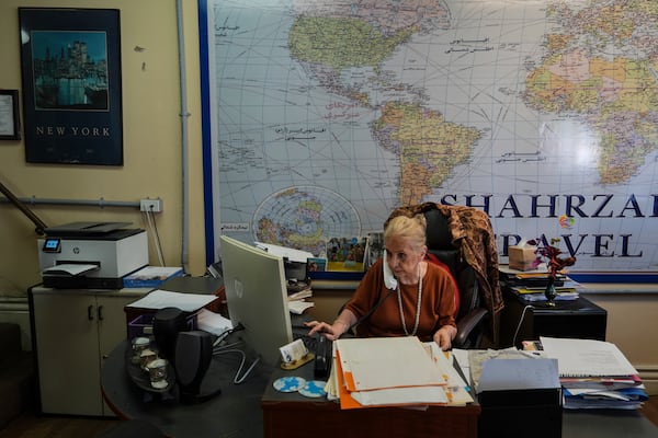 Shahrzad Tahouri works at her travel agency in the "Tehrangeles" neighborhood of Los Angeles Tuesday, June 24, 2025. (AP Photo/Jae C. Hong)