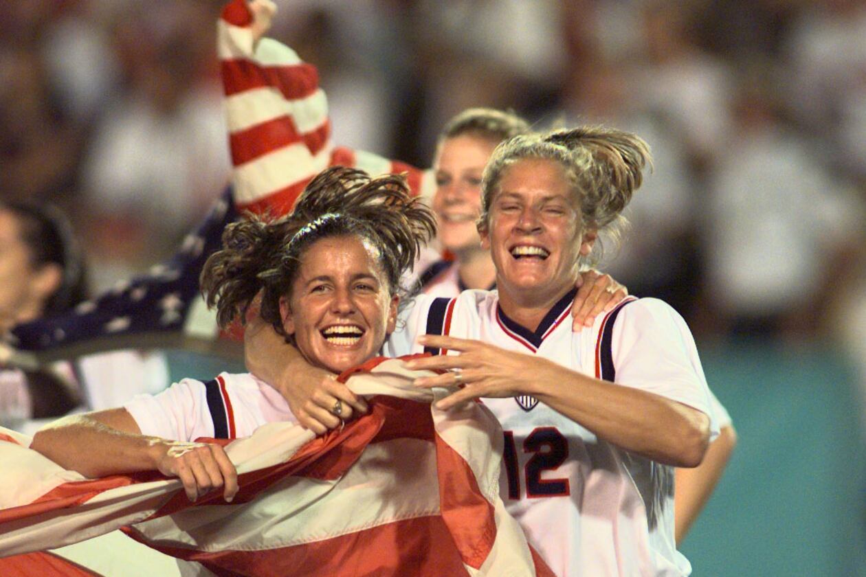Joy Fawcett (left) and Carin Gabarra (right) run around Sanford Stadium in Athens with an American flag after their historic 2-1 gold medal win over China Thursday, Aug. 1, 1996, during the 1996 Summer Olympic Games. (David Tulis/AJC)