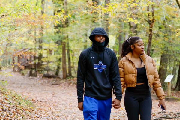 Jermarcas Gaines and Lexi Lewis walk along Sweetwater Creek on Thursday, Oct. 30, 2025. Georgia’s Board of Natural Resources has voted to double the entrance fee at state parks. “Nature is free,” Lewis says. “It should be accessible to everyone.” (Miguel Martinez/AJC)