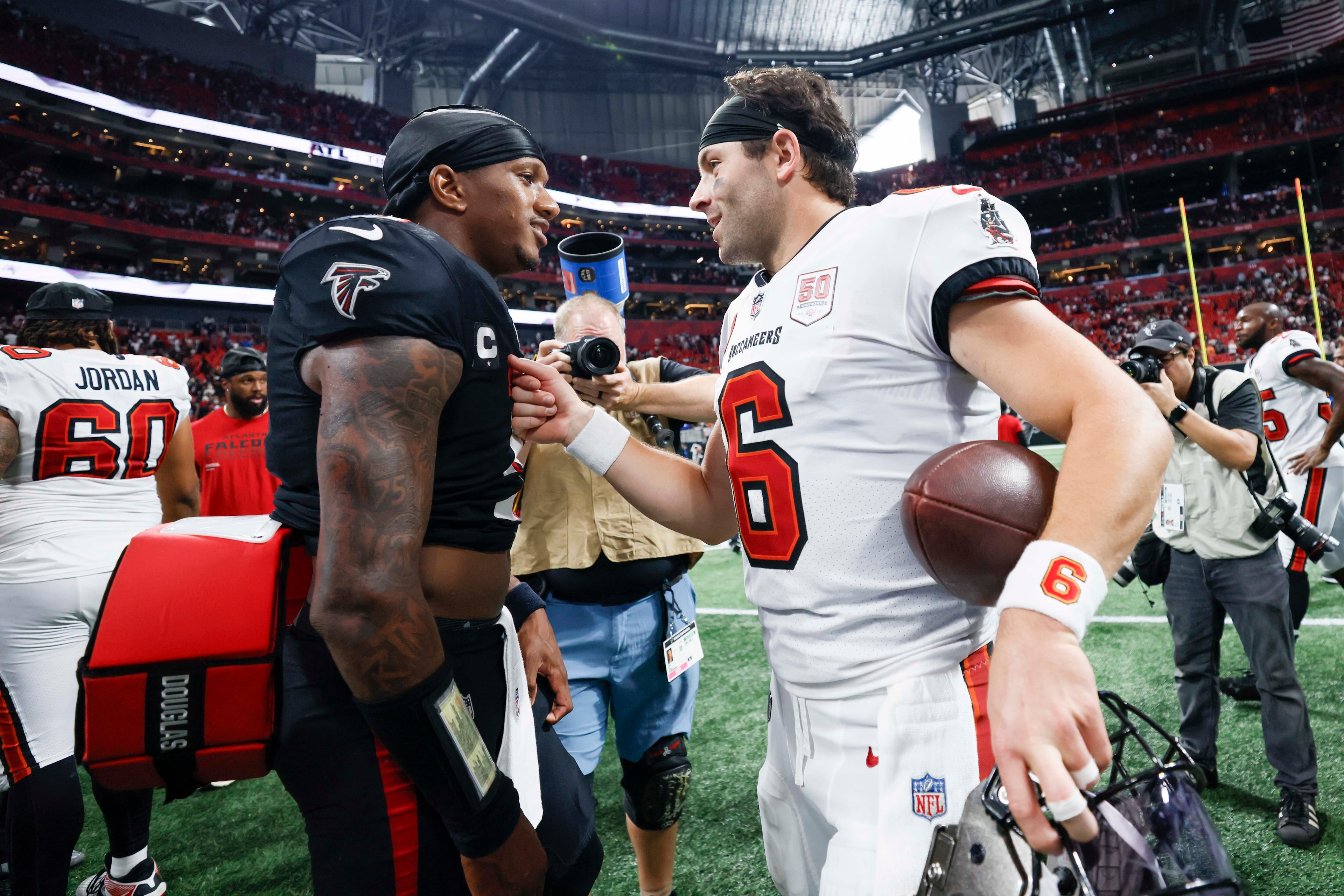 Atlanta Falcons quarterback Michael Penix Jr. (9) and Tampa Bay Buccaneers quarterback Baker Mayfield (6) exchange words at the end of the game after the Tampa Bay Buccaneers defeated the Atlanta Falcons 23-20 at Mercedes-Benz Stadium on Sunday, September 7, 2025, in Atlanta.
(Miguel Martinez/ AJC)