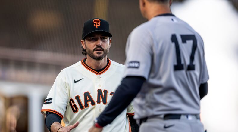 San Francisco Giants manager Tony Vitello reaches out to shake hands with Yankees manager Aaron Boone (17) during introductions before the San Francisco Giants played the New York Yankees in their 2026 Opening Day at Oracle Park in San Francisco, on Wednesday, March 25, 2026. (Santiago Mejia/San Francisco Chronicle via AP)