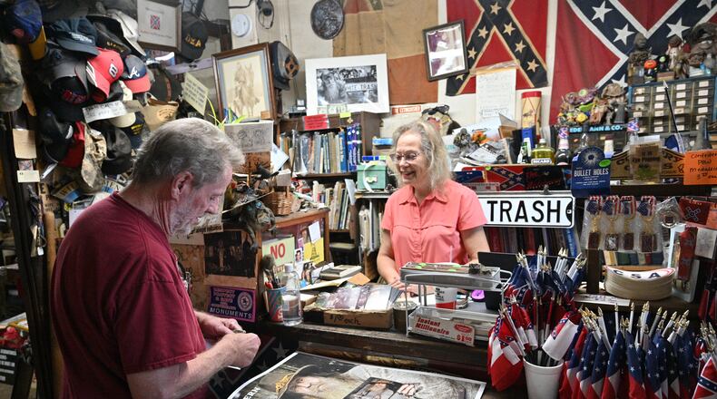 June 16, 2022 Kennesaw - Marjorie Lyon (right), the new owner, helps a longtime customer Mickey Magruder at Wildman's Civil War Surplus in Kennesaw on Thursday, June 16, 2022. The store first opened in downtown Kennesaw in 1971. When the owner, Dent Myers died in January, Marjorie Lyon vowed to keep the shop open. Councilman James “Doc” Eaton resigned from Kennesaw City Council Tuesday over the reopening of Wildman’s Civil War shop. (Hyosub Shin / Hyosub.Shin@ajc.com)