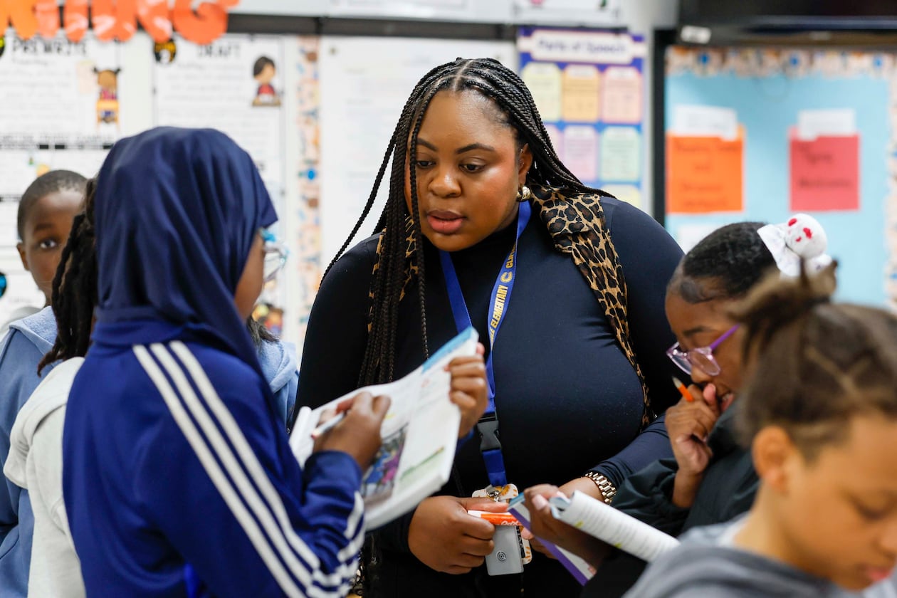 Elementary teacher Ashley Hill works with fifth grade students at Cliftondale Elementary in March. (Miguel Martinez/AJC)