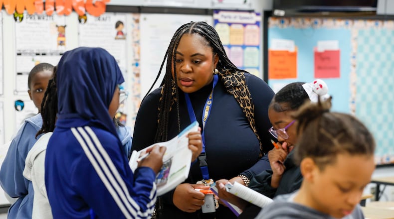 Elementary teacher Ashley Hill works with fifth grade students at Cliftondale Elementary in March. (Miguel Martinez/AJC)