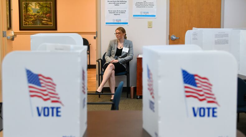 Poll worker Brittni Nix waits to assist voters during special election voting at city hall to fill an empty city council seat on Tuesday, March 24, 2020, in Dacula. The voting happens to occur on a day that was supposed to be the test run for the state's new election system before coronavirus COVID-19 caused it to be called off.