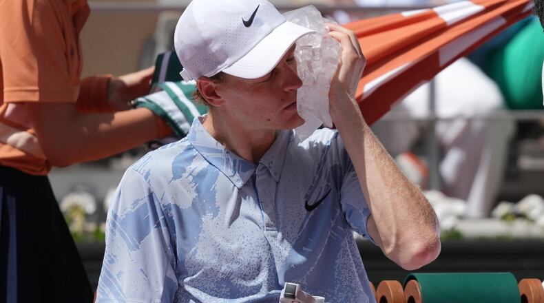 Jannik Sinner of Italy cools himself with the ice during the second round men's singles tennis match against Juan Manuel Cerundolo of Argentina at the French Open tennis tournament in Paris, Thursday, May 28, 2026. (AP Photo/Thibault Camus)