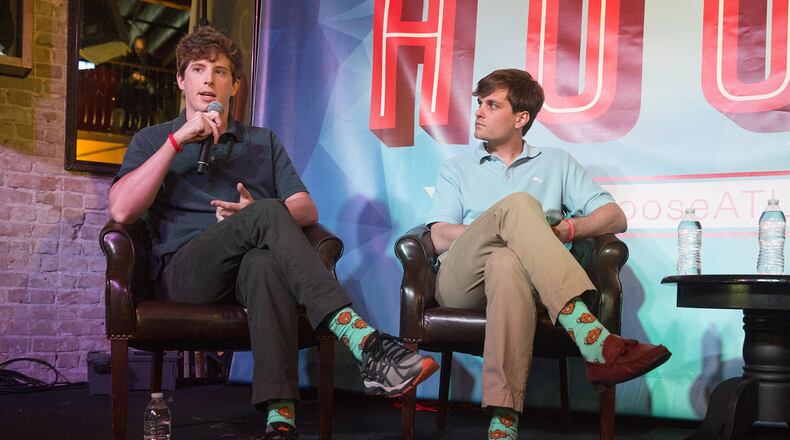 Yik Yak founders Brook Buffington (left) and Tyler Droll discuss their app in Austin, Texas, last year. (John Clark for Journal Constitution)