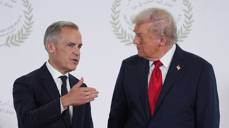 President Donald Trump greets Canada's Prime Minister Mark Carney during a summit to support ending the more than two-year Israel-Hamas war in Gaza after a breakthrough ceasefire deal, Monday, Oct. 13, 2025, in Sharm El Sheikh, Egypt. (AP Photo/Evan Vucci, Pool)