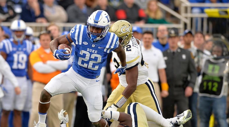 DURHAM, NC - NOVEMBER 18:  Brittain Brown #22 of the Duke Blue Devils breaks away from Brentavious Glanton #97 of the Georgia Tech Yellow Jackets for a long gain during their game at Wallace Wade Stadium on November 18, 2017 in Durham, North Carolina.  (Photo by Grant Halverson/Getty Images)