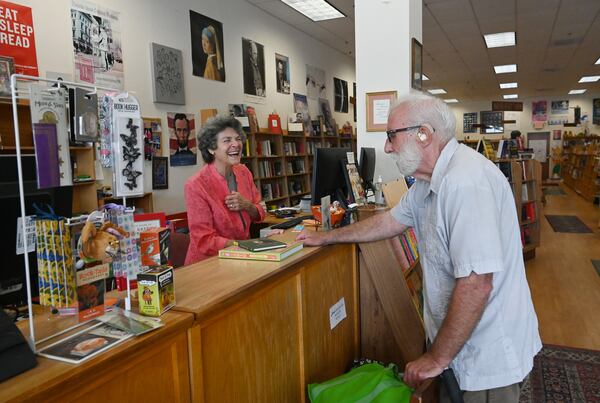 Eve Shulmister, left, a longtime, beloved bookseller at Tall Tales Book Shop, helps customer Dan Boles on Wednesday, July 8, 2026, in Atlanta. The 46-year-old bookstore will face new competition this summer when a Barnes & Noble opens in an adjacent shopping center. (Hyosub Shin/AJC)