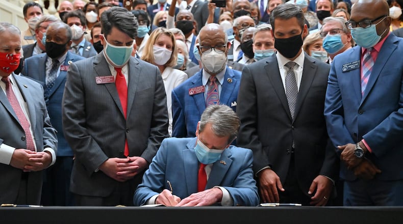 June 26, 2020 Atlanta - Gov. Brian Kemp signs HB 426, hate-crimes legislation, into law on the last day of the legislative session at Georgia State Capitol on Friday, June 26, 2020. Gov. Brian Kemp signed hate-crimes legislation into law on Friday after state lawmakers brokered a compromise over the proposal after 16 years of debate over whether to extend protections to people who are targeted because of biases. (Hyosub Shin / Hyosub.Shin@ajc.com)