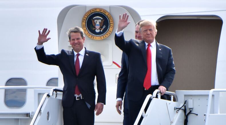 GOP gubernatorial candidate Brian Kemp and President Donald Trump wave from Air Force One as President Donald J. Trump arrives during President Donald J. Trump's Make America Great Again Rally to support Brian Kemp at Middle Georgia Regional Airport in MaconSunday, November 4, 2018. HYOSUB SHIN / HSHIN@AJC.COM
