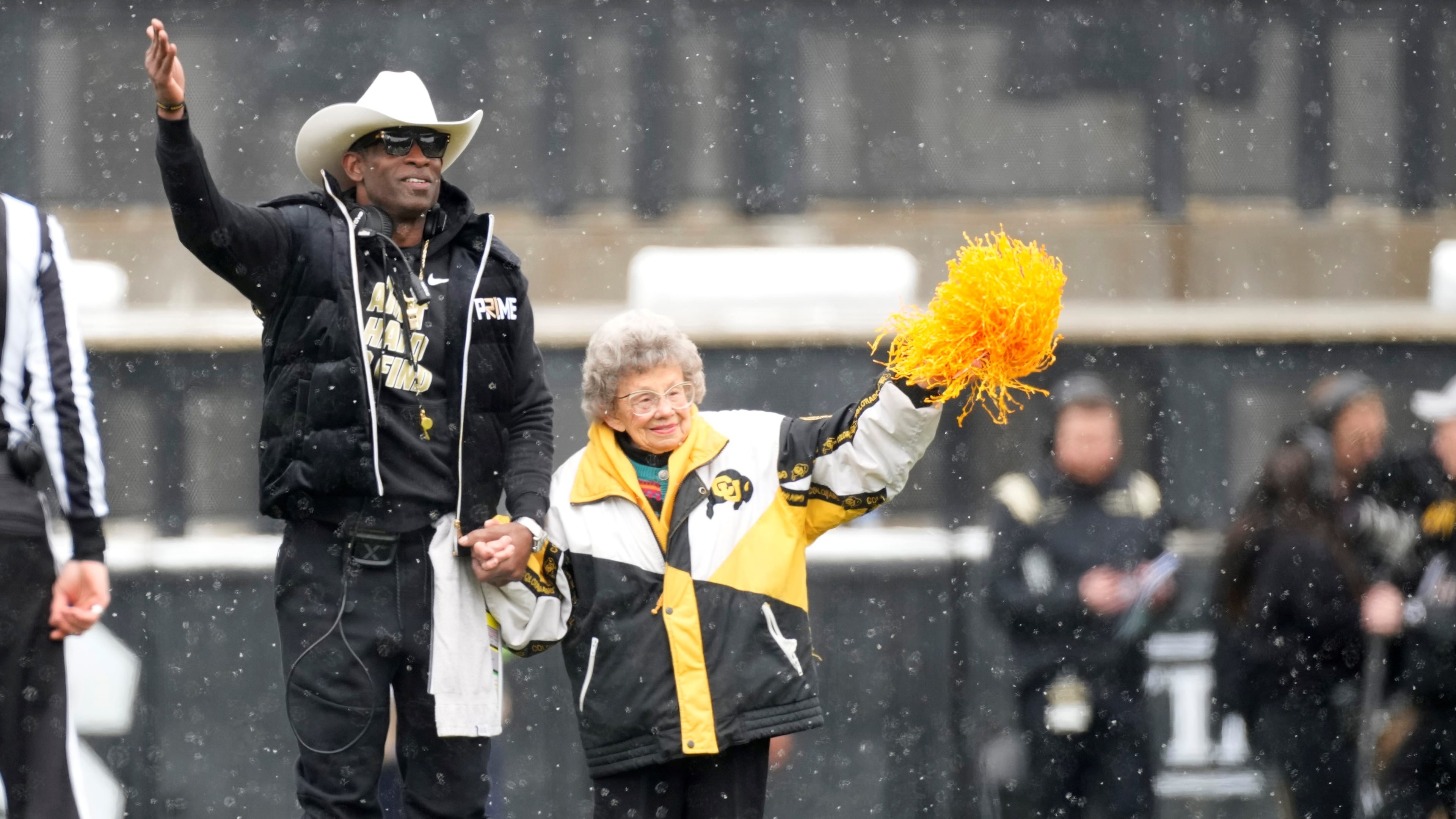 Colorado coach Deion Sanders walks with longtime supporter Peggy Coppom. Coppom, who tuns 101 in November, is good friends with Sanders. (David Zalubowski/AP 2023)