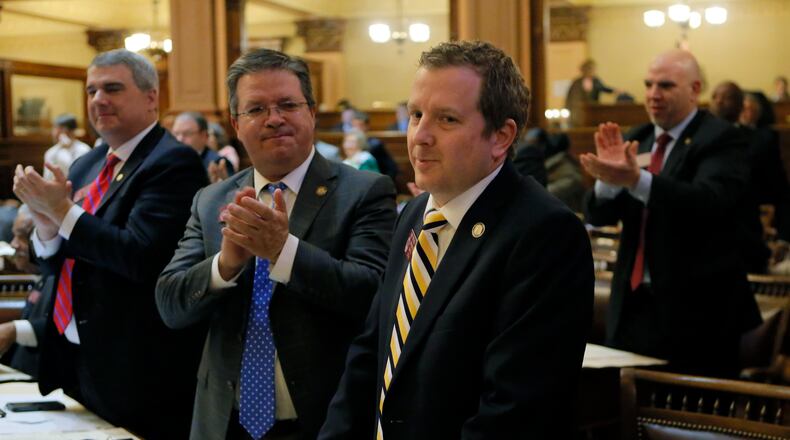 State Rep. Bert Reeves, R - Marietta, receives an ovation after the vote on SB 130, which had his adoption bill added. It passed the House 159-0 shortly before midnight. Bob Andres, bandres@ajc.com