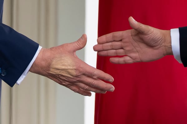 FILE - President Donald Trump, left, reaches to shake hands with Bahrain's Crown Prince Salman bin Hamad Al Khalifa speak upon his arrival at the White House, July 16, 2025, in Washington. (AP Photo/Alex Brandon, File)