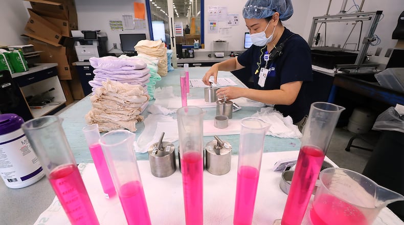 Officials at Medline's Lithia Springs plant say they think rotating shifts are an attraction to workers, since they have weekdays off so often. Here, Daisy Foreman runs tests in the Medline quality assurance lab. “Curtis Compton / Curtis.Compton@ajc.com”