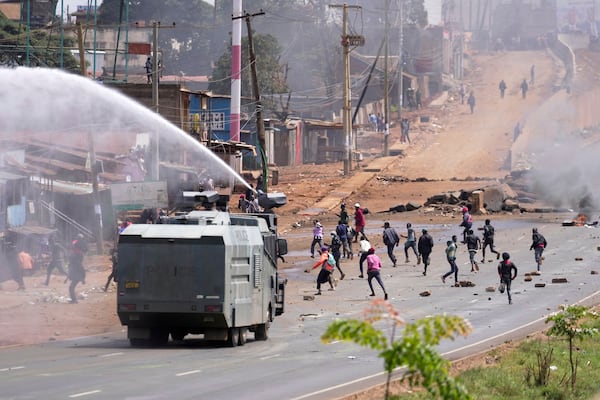 Riot police scatter protesters with water canons during the historic 1990 "Saba Saba" a Swahili word that means seven seven, protests for democratic reforms in the Kangemi slum of Nairobi, Kenya Monday, July 7, 2025. (AP Photo/Brian Inganga)