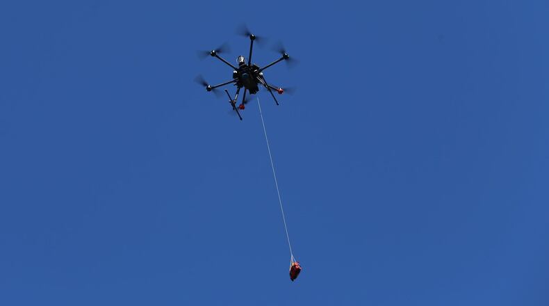 A drone in Sweden winches down a defibrillator for use during medical emergencies.