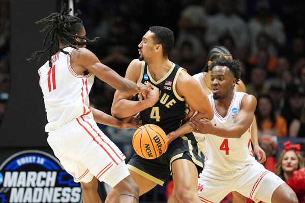 Purdue's Trey Kaufman-Renn, center, has the ball knocked away by Houston's L.J. Cryer, right, and Joseph Tugler (11) during the first half in the Sweet 16 of the NCAA college basketball tournament Friday, March 28, 2025, in Indianapolis. (AP Photo/Michael Conroy)