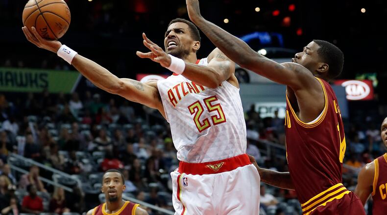 Atlanta Hawks forward Thabo Sefolosha (25) goes to the basket as Cleveland Cavaliers guard DeAndre Liggins (14) defends in the first half of a preseason NBA basketball game Monday, Oct. 10, 2016, in Atlanta. (AP Photo/John Bazemore)