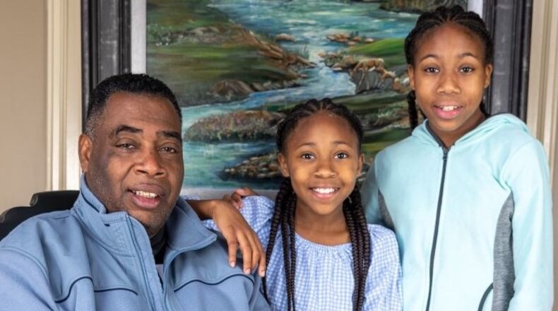 Rainbow Village Resident Darran E and granddaughters support the nonprofits campaign to raise awareness about homelessness. (Courtesy Rainbow Village)