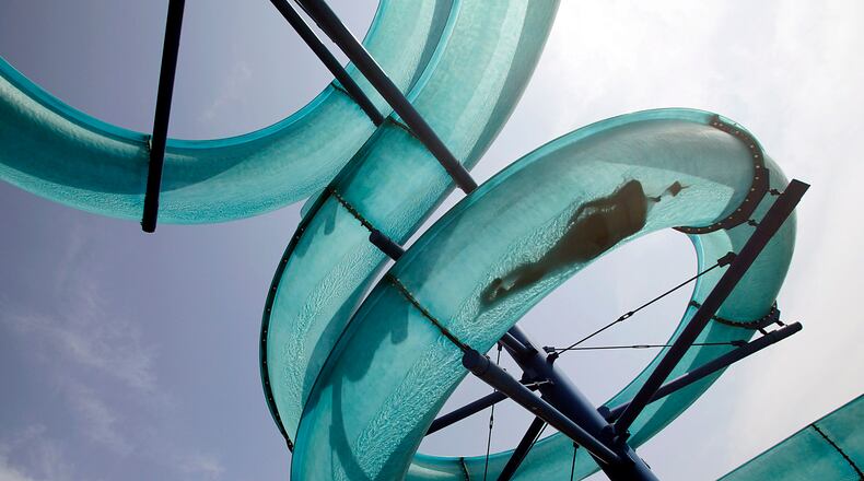 A person slides down a huge water pipe at a public swimming pool on a hot sunny day in Vienna July 29, 2013. Temperatures in Austria's capital Vienna reached nearly 36 degrees Celsius (97 Fahrenheit) Monday, but Austria's Central Institute for Meteorology and Geodynamics predicts a possible record temerature of 39 degrees Celsius (102 Fahrenheit) in the next days. REUTERS/Leonhard Foeger (AUSTRIA - Tags: ENVIRONMENT SOCIETY TPX IMAGES OF THE DAY)