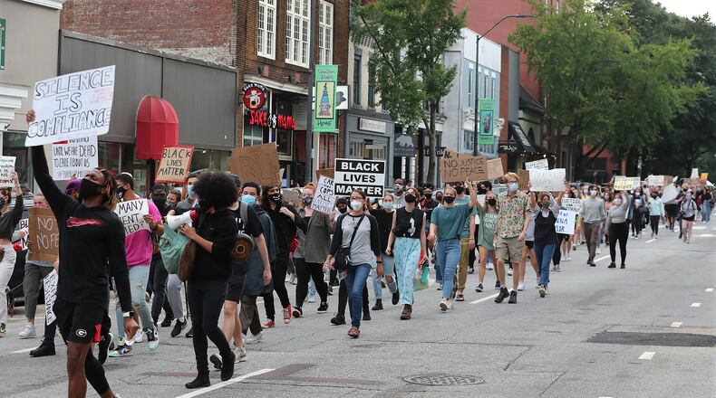 University of Georgia students take to the streets and march down East Clayton Street from the UGA arch during a Black Lives Matter protest in support of Breonna Taylor on Sept. 25 in Athens. (Curtis Compton / Curtis.Compton@ajc.com)