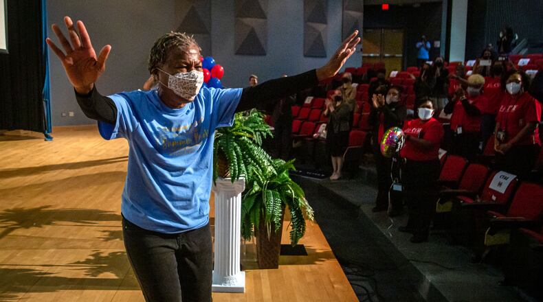 Mays High School teacher Sonja Lewis reacts after learning she won a free trip including airfare and hotel accommodations to any Delta Vacations destination within the U.S., Mexico, or the Caribbean on Friday, May 7 2021.  STEVE SCHAEFER FOR THE ATLANTA JOURNAL-CONSTITUTION