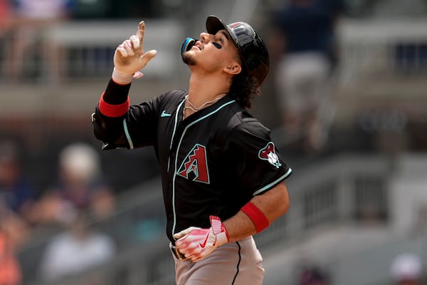 Arizona Diamondbacks outfielder Alek Thomas (5) celebrates his two-run homer against the Atlanta Braves in the eighth inning of a baseball game, Thursday, June 5, 2025, in Atlanta. (AP Photo/Mike Stewart)