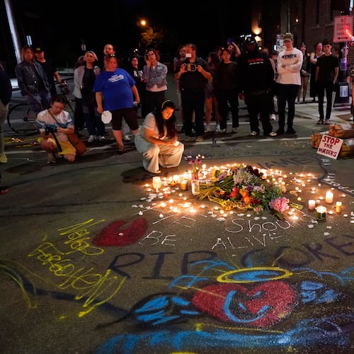 Attendees gather at a candlelight vigil where a Madison police officer shot and killed a man Wednesday, July 22, 2026, in Madison, Wis. (AP Photo/Kayla Wolf)