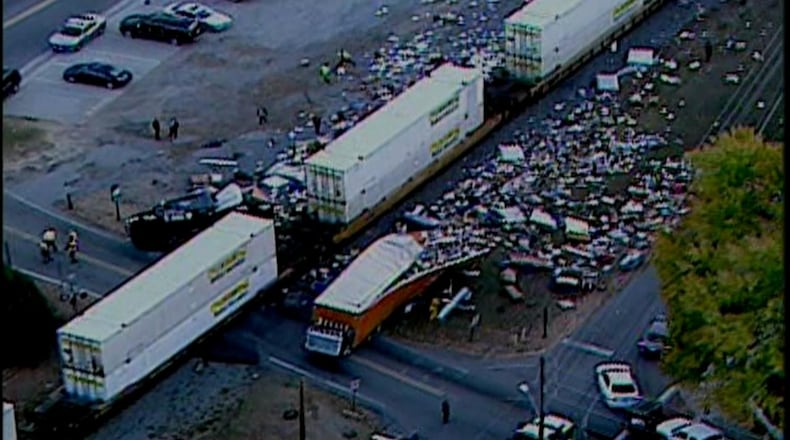 A truck and train collided at the intersection of Holcomb Bridge Road and South Peachtree Street, police said. (Credit: Channel 2 Action News)