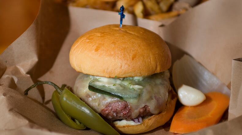 "The Burger" at Muss & Turner's in Smyrna features grass-fed beef topped with grilled poblano pepper, red onion, white cheddar and cilantro aioli.