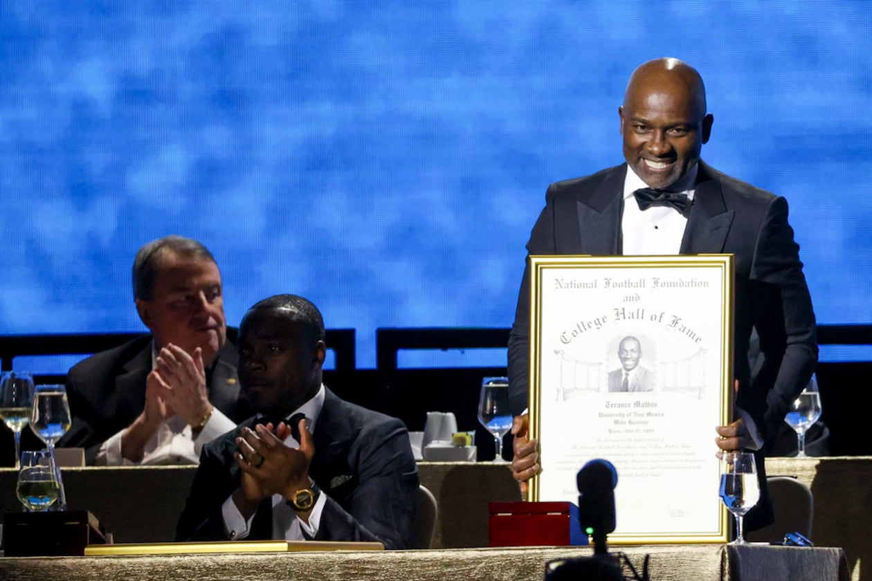 Former New Mexico wide receiver Terance Mathis holds up his College Football Hall of Fame Award during the National Football Foundation Awards Dinner, Tuesday, Dec. 5, 2023, in Las Vegas. (Ian Maule/AP)