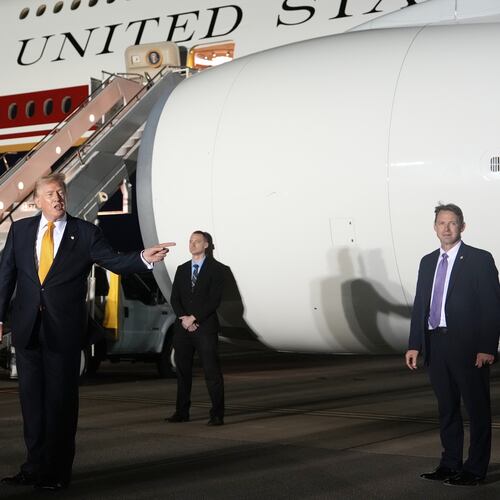 Surrounded by security, President Donald Trump switches planes at U.S. Air Force Base, RAF Mildenhall in Suffolk Eastern England, on his way back to Washington from the NATO summit in Ankara, Turkey, Wednesday, July 8, 2026. (AP Photo/Alex Brandon)