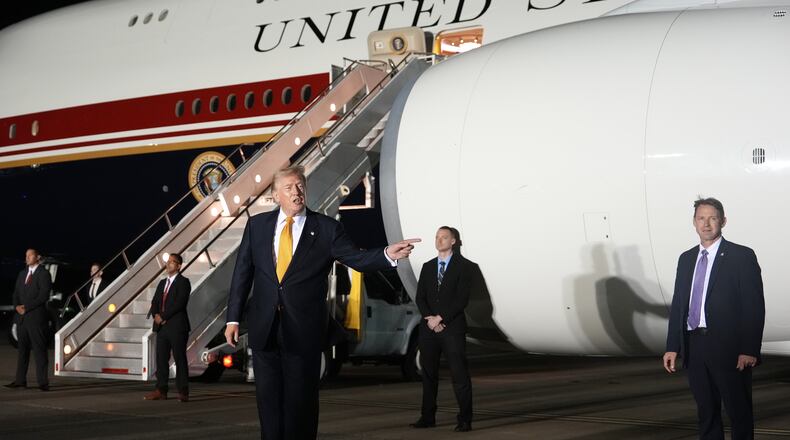 Surrounded by security, President Donald Trump switches planes at U.S. Air Force Base, RAF Mildenhall in Suffolk Eastern England, on his way back to Washington from the NATO summit in Ankara, Turkey, Wednesday, July 8, 2026. (AP Photo/Alex Brandon)