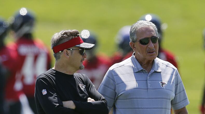 Atlanta Falcons owner Arthur Blank, right, talks with general manager Thomas Dimitroff during NFL minicamp football Thursday, June 15, 2017, in Flowery Branch, Ga. (AP Photo/John Bazemore)