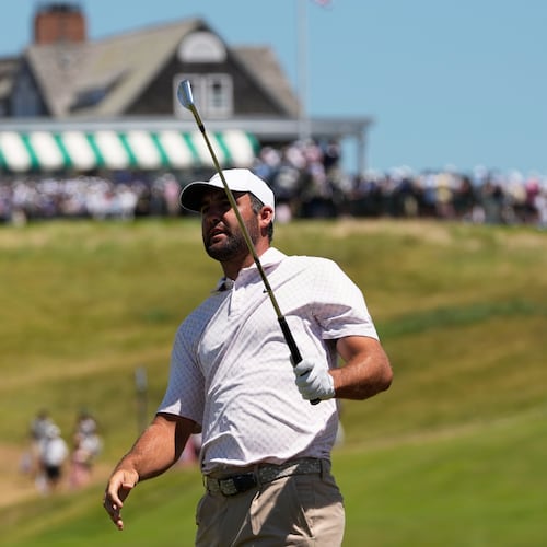 Scottie Scheffler watches his shot on the first hole during the third round of the U.S. Open golf tournament at Shinnecock Hills Golf Club in Southampton, N.Y., Saturday, June 20, 2026.(AP Photo/David J. Phillip)