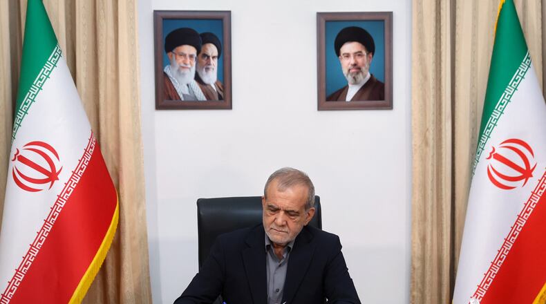 In this photo realised by Iran Presidentcy Office, Iranian President Masoud Pezeshkian signs a memorandum of understanding already signed by U.S. President Donald Trump aimed at ending the war and launching negotiations on a broader agreement, in Tehran, Iran, early Thursday, June 18, 2026. (Iranian Presidency Office via AP)