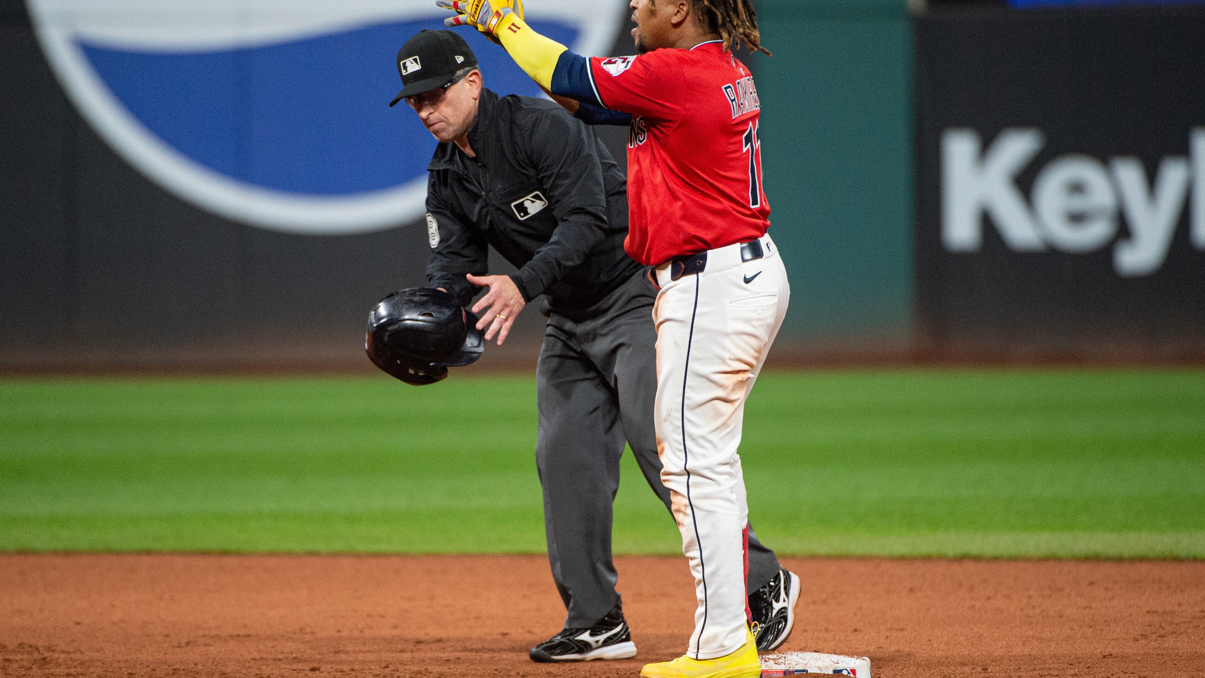Cleveland Guardians' Jose Ramirez, right, reacts after hitting a two-run RBI double off Detroit Tigers relief pitcher Will Vest as umpire Chris Guccione, left, picks up his helmet during the seventh inning of a baseball game, Wednesday, Sept. 24, 2025, in Cleveland. (AP Photo/Phil Long)