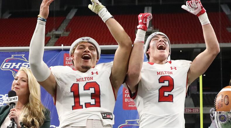 December 12, 2018 - Atlanta, Ga: Milton quarterback Jordan Yates, left, and wide receiver Dylan Leonard (2) celebrate their 14-13 win against Colquitt County in the Class AAAAAAA State Championship at Mercedes-Benz Stadium Wednesday, December 12, 2018, in Atlanta. Milton won 14-13. (JASON GETZ/SPECIAL TO THE AJC)