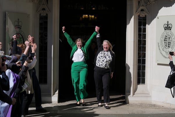 Marion Calder and Susan Smith from For Women Scotland, celebrate outside the Supreme Court to challenge gender recognition laws, in London, Wednesday, April 16, 2025. For Women Scotland is challenging the Scottish Government over whether trans women can be regarded as female for the purposes of the 2010 Equality Act. (AP Photo/Kin Cheung)
