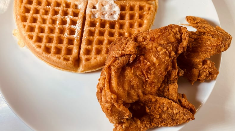The signature dish at Johnny’s Chicken & Waffles can be ordered with a choice of protein, a plain or red velvet waffle and several sauces. Bob Townsend for The Atlanta Journal-Constitution