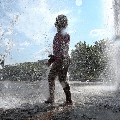 Paulina Lopez, 4, plays in the Big Splash fountain at Town Center Park on Wednesday, Sept. 2, 2026, in Suwanee. The National Weather Service predicts hot and humid conditions for the long Labor Day weekend. (Hyosub Shin/AJC)